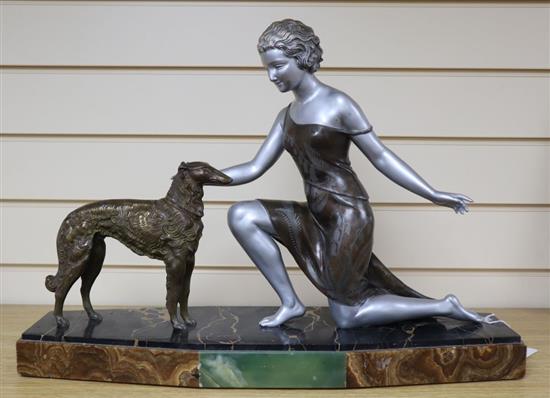 U.Cipriani - An Art Deco style figure of a kneeling lady and a dog, signed, (patinated spelter), on angular marble plinth, 56cm wide